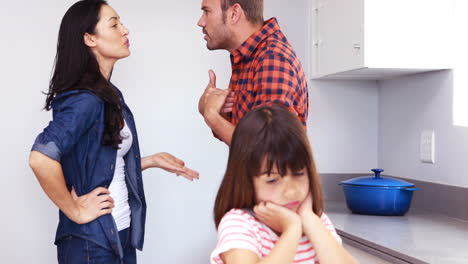 couple arguing in front of their daughter