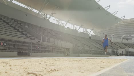 mixed race athlete doing long jump