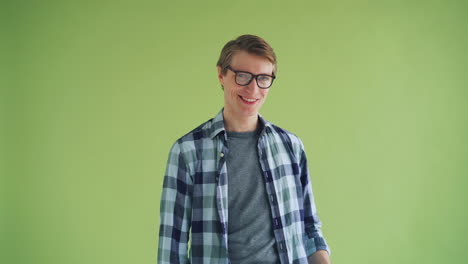 man posing in front of a green background
