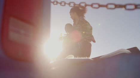 woman on mans lap sitting on a pickup truck at beach 4k