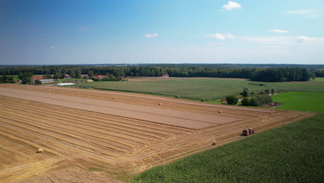 aerial view of tractor toiling for harvest in agriculture farm land