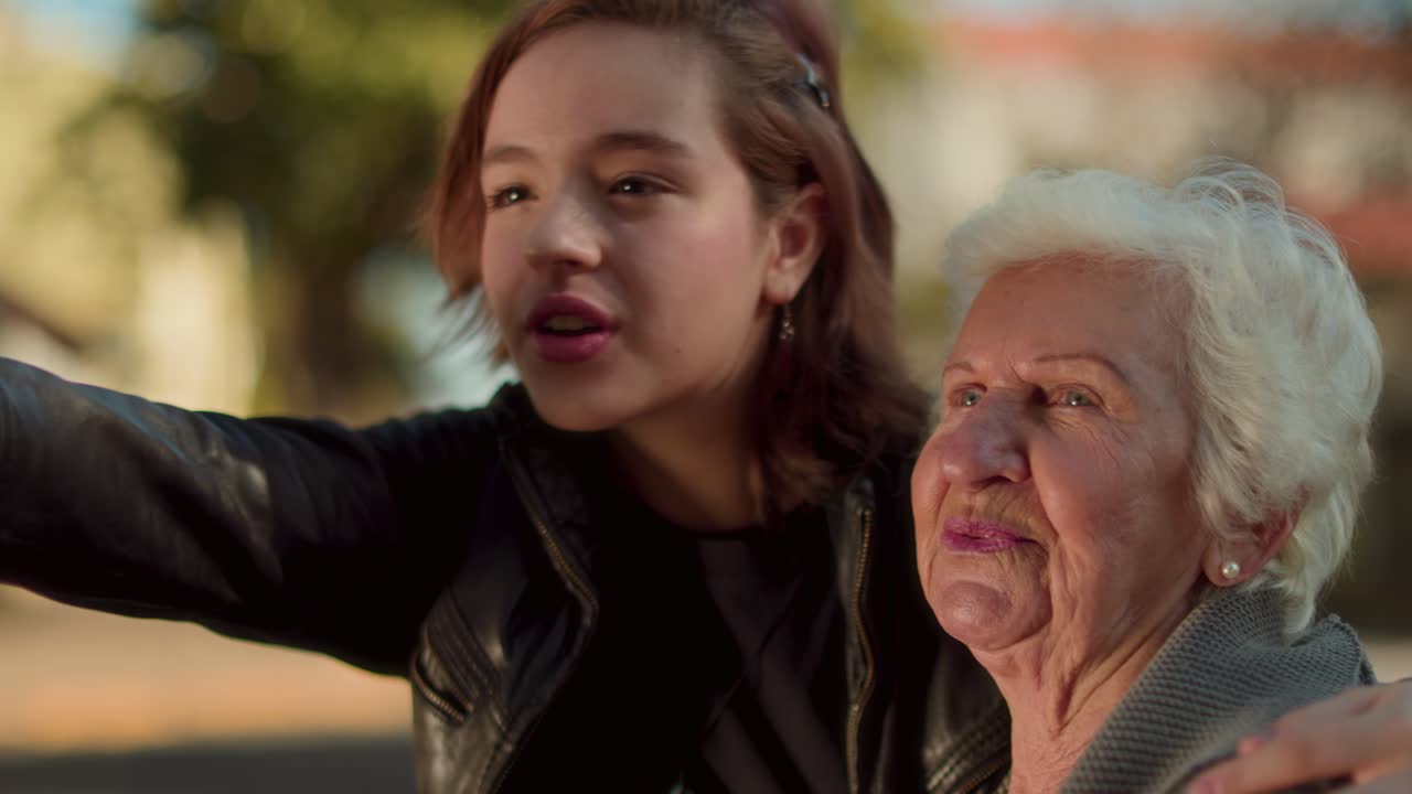 Elderly Woman and Young Woman Interacting Outdoors