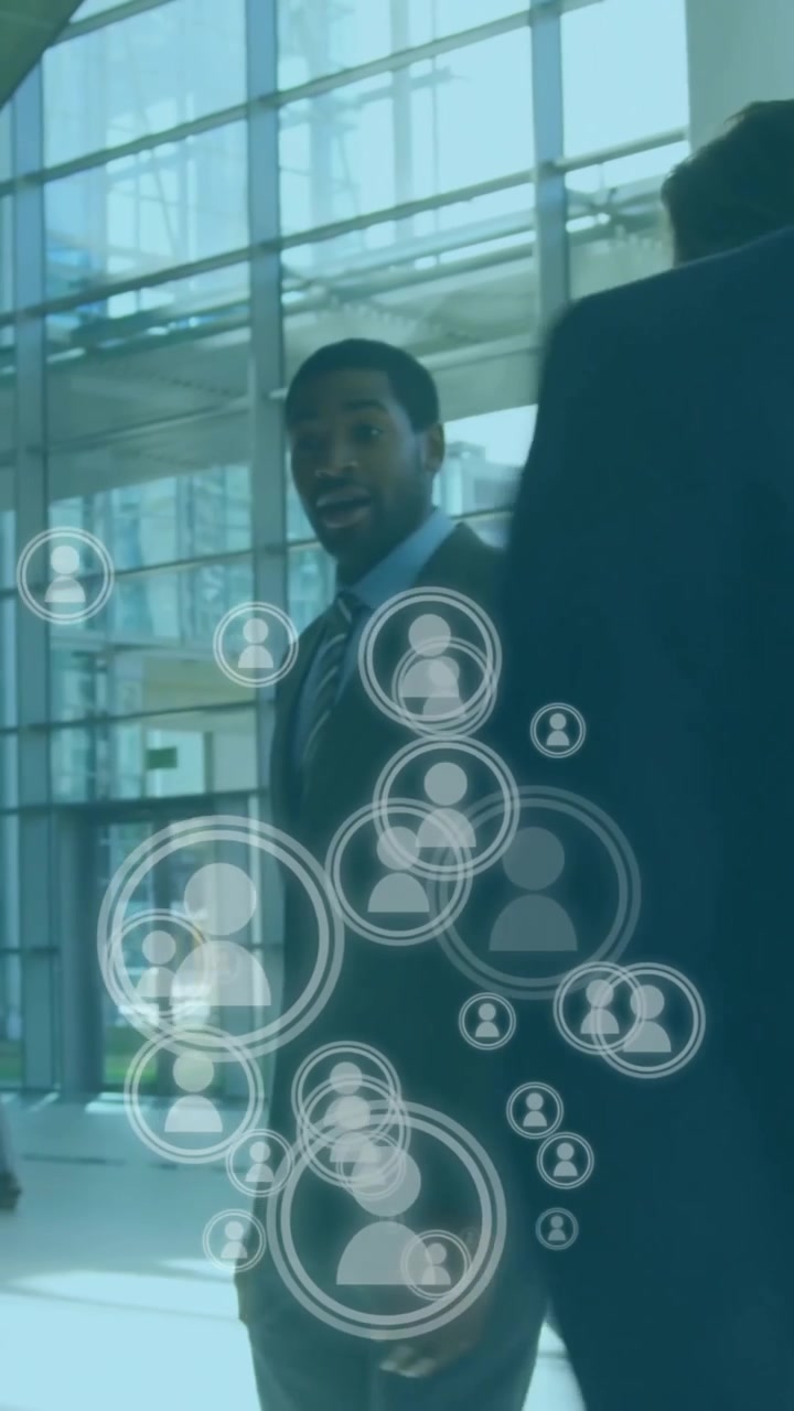 Animation of people icons over caucasian businesspeople networking
