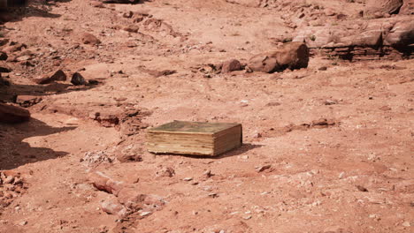 old book in red rock desert