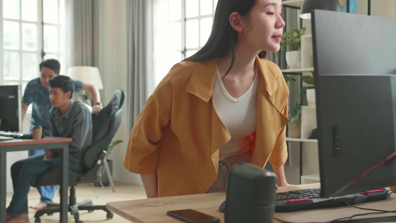 Asian Female Start Works On Her Personal Computer With Big Display In Office