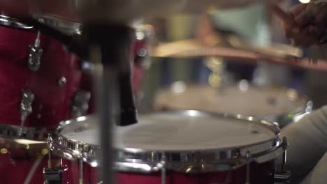 a woman playing on drum in the theatre static shot, close up shot, insert shot