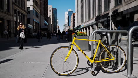 yellow bicycle parked on a city sidewalk