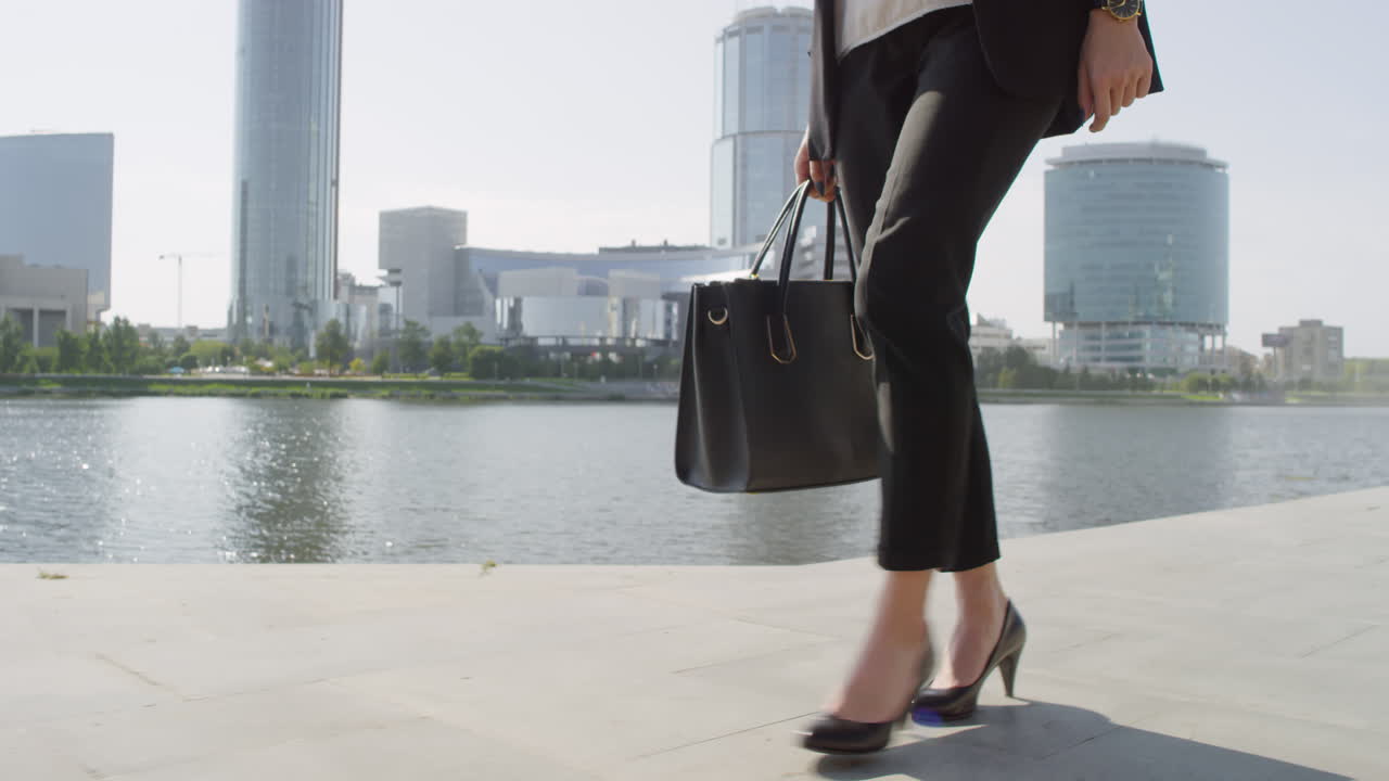 Female Legs On Heels Walking Along River