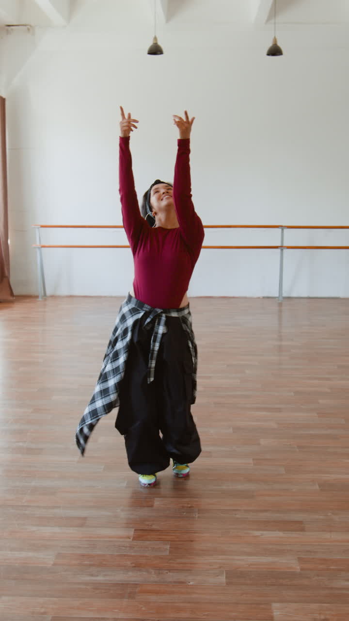 A woman dancing energetically in a studio