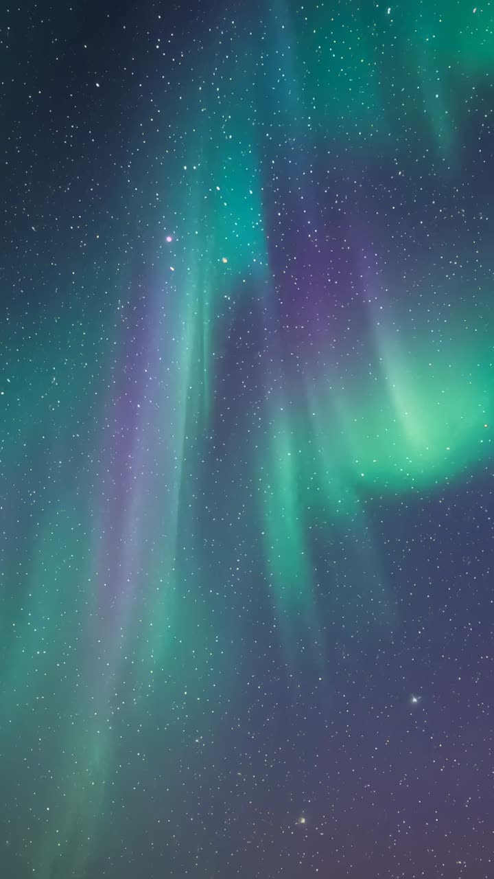 Vertical video: Forming curtain sparking aurora spiraling over polar sky, green purple horizon glow