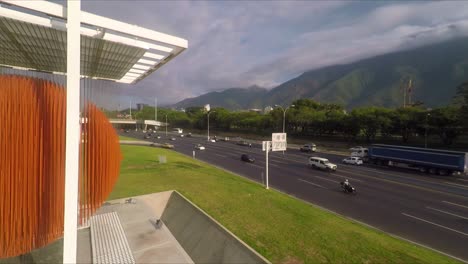 drone passing by the 'esfera caracas', with the francisco fajardo highway and the ávila mountain behind, in caracas, venezuela