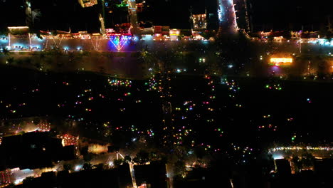 Night-time-aerial-view-of-colorful-lantern-boats-in-Hoi-An,-Vietnam