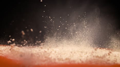 Powder-explosion-on-orange-and-black-background-in-super-slow-motion