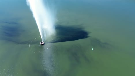 drone aerial landscape of kayak paddling next to jets spraying water in memorial fountain in lake burley griffin reservoir basin canberra city capital act australia travel tourism leisure outdoors