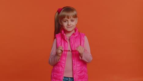 Seductive-cheerful-stylish-girl-in-blouse-and-vest-wearing-sunglasses,-charming-smile-on-pink-wall