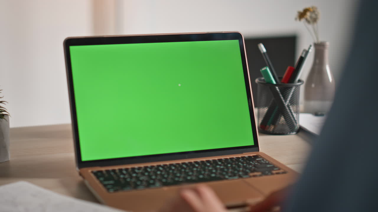 Student studying green screen laptop at home workplace closeup. Man watching
