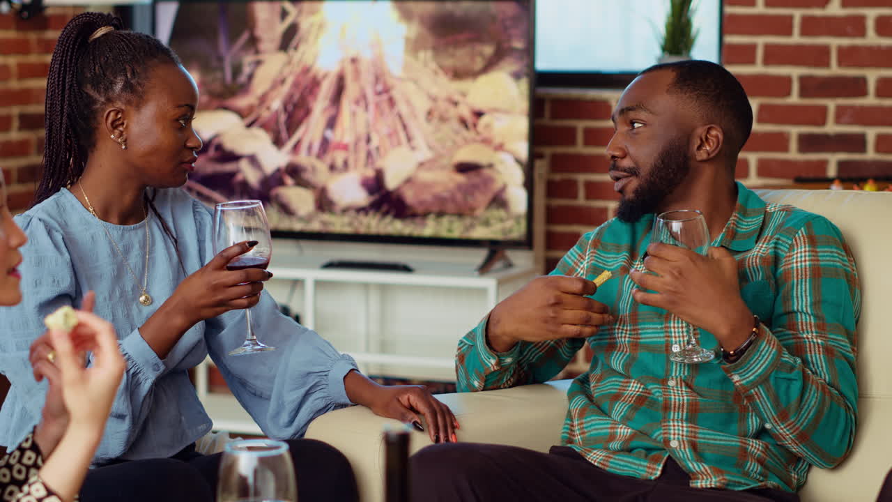 BIPOC husband and wife enjoying nice conversation, gossiping about other guests