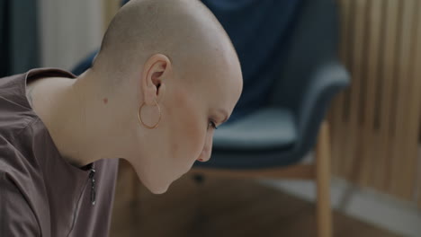 Woman with Bald Head, Working on a Desk