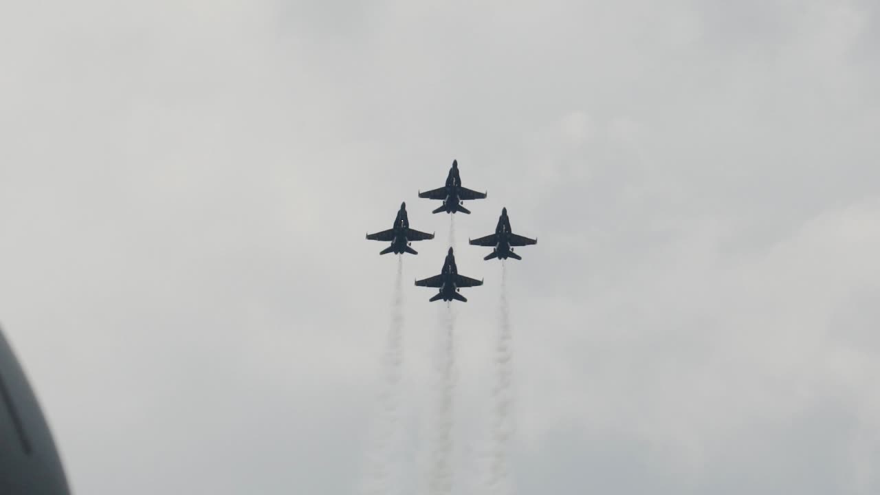 Blue Angels Flying In Formation Of Four Together Side By Side At Airport Airshow In Summer