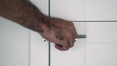 locking up privacy: slow motion of sliding door bolt on a white surface