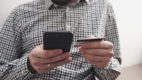 person making an online payment with a credit card and smartphone