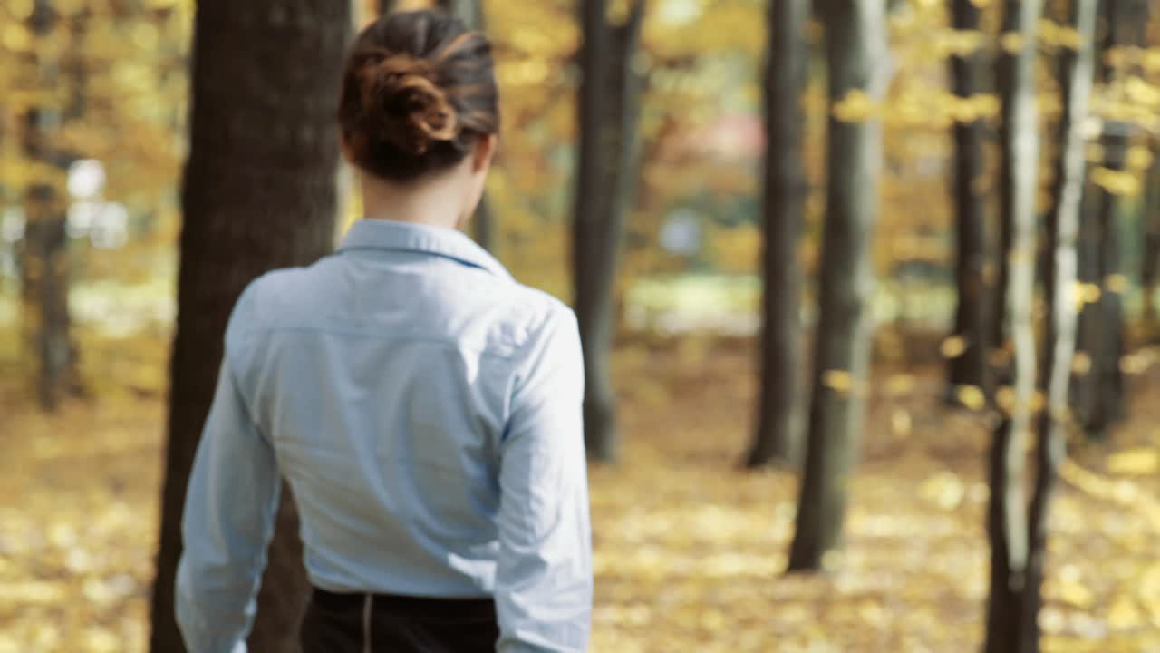 Girl walking in park. Attractive woman walking in autumn forest