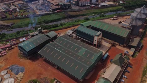 beautiful jib up of a large factory with smoke coming from the chimneys on a large industrial site in ibadan, nigeria