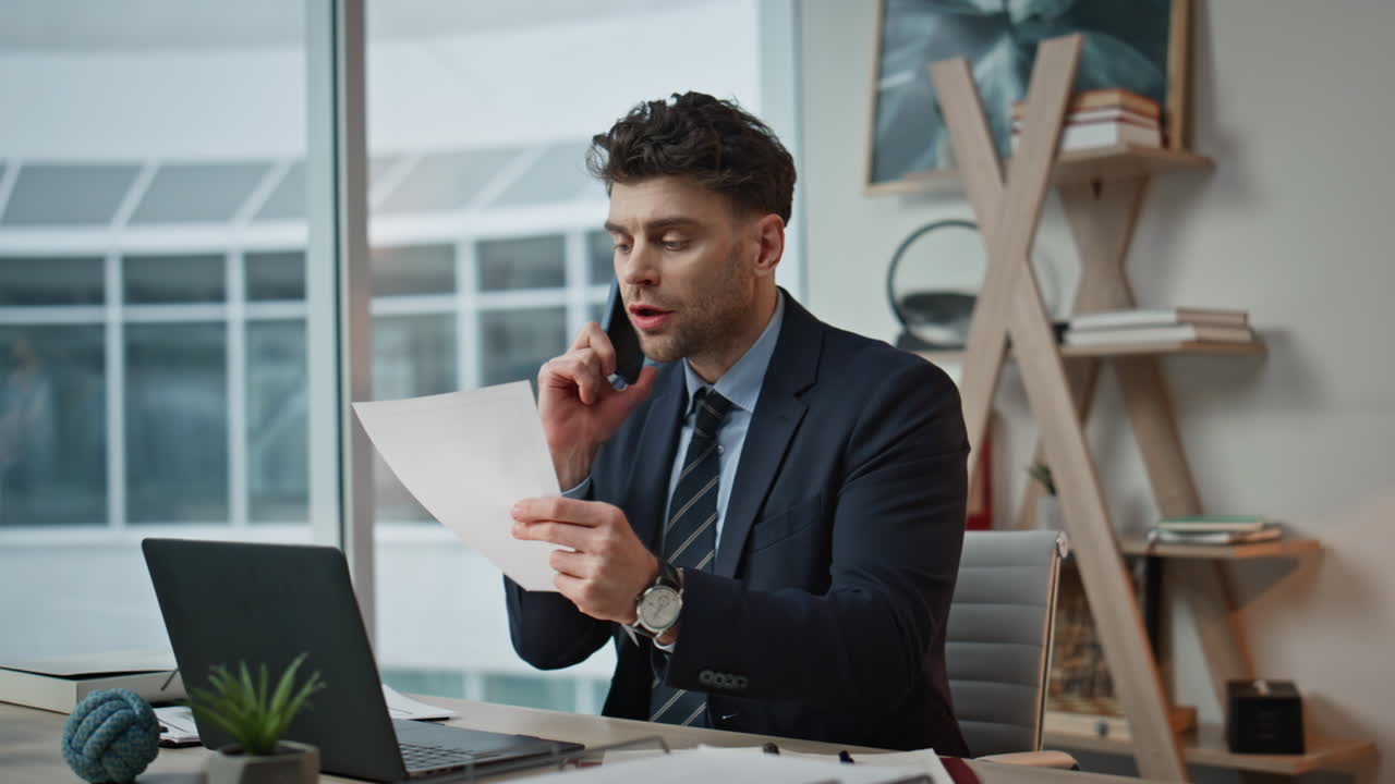 Businessman have nervous call by mobile phone in modern office interior closeup