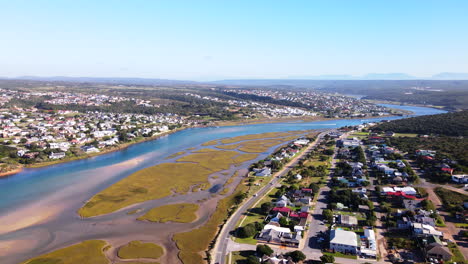 Aerial-tilt-up-view-over-Stilbaai-east-along-stunning-Goukou-river-estuary