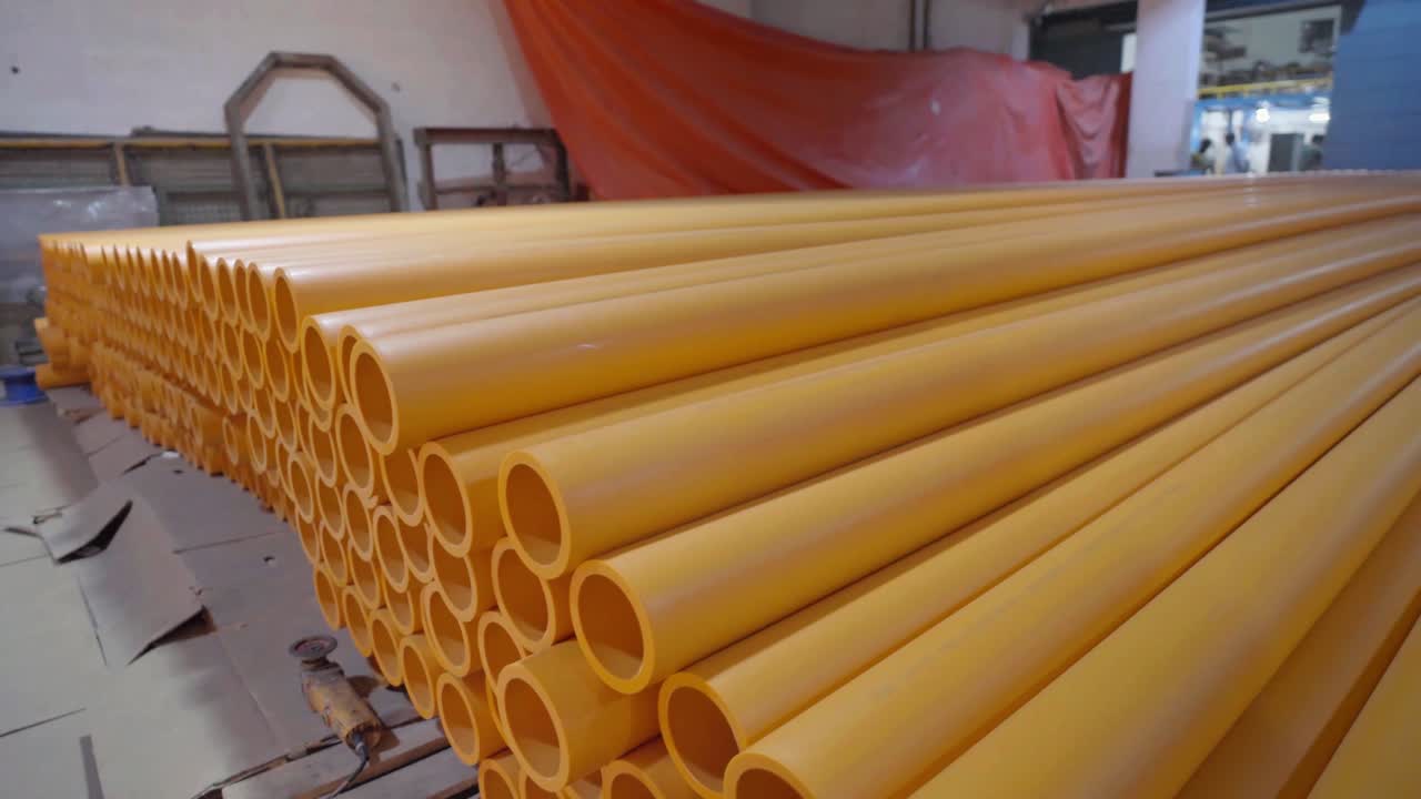 Shot of prepared yellow PVC pipe stacked up for distribution to market from PVC Pipe Making Factory in Karachi, Pakistan.