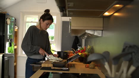 young woman dicing a white onion