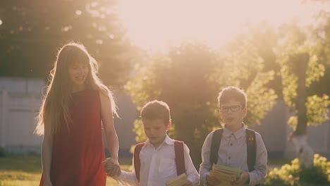 lady with long loose flowing hair walks with children