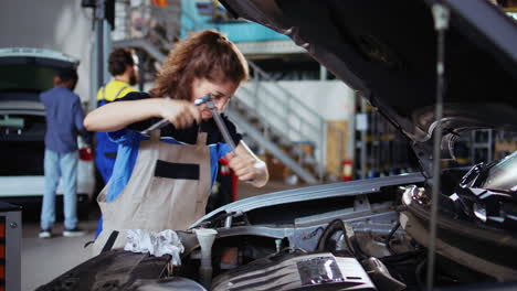 serviceman in garage cleans clients car