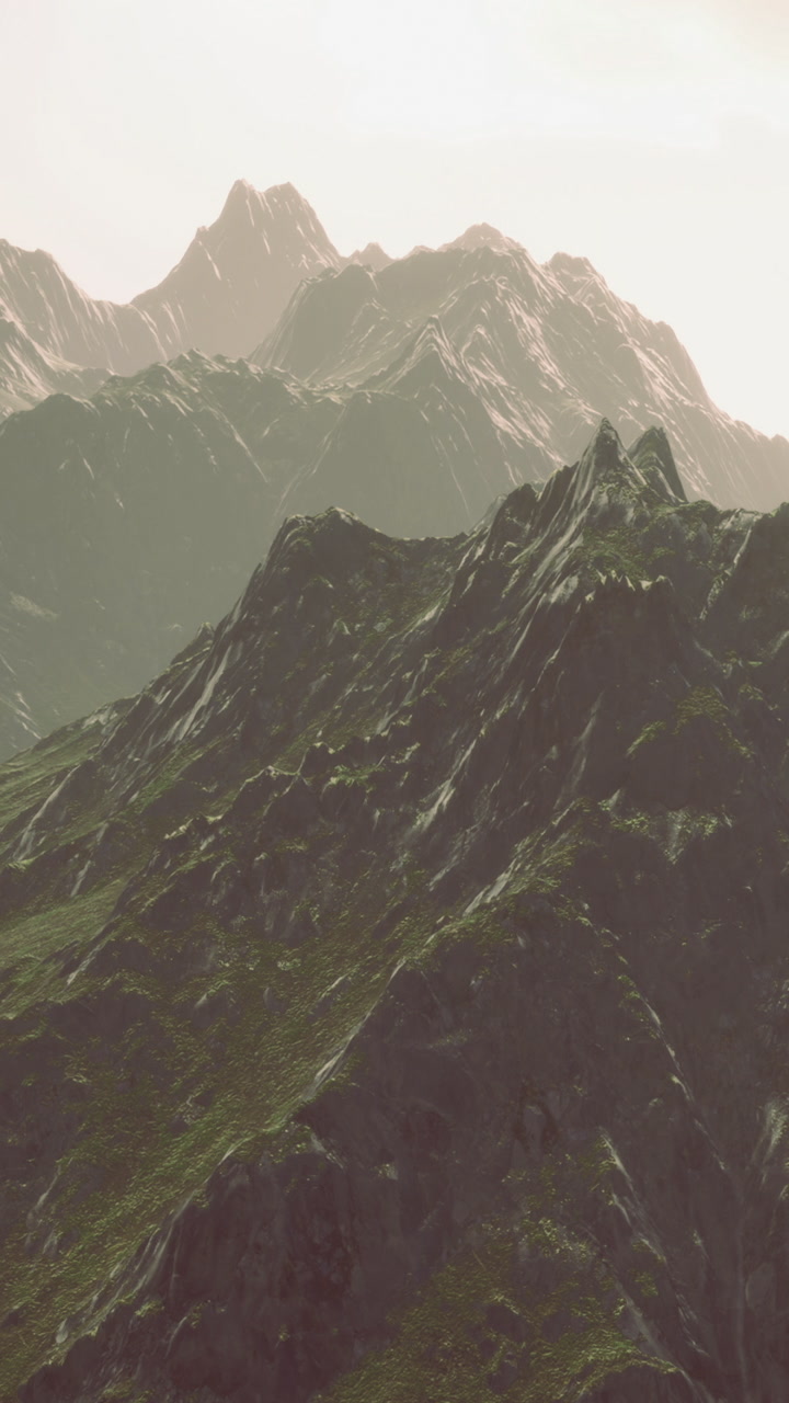 Mountain peaks rise under sunlight with clear sky in the background