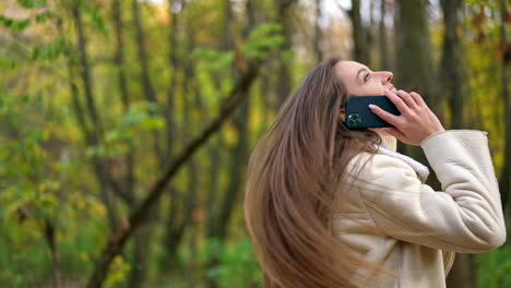 woman talking on phone in autumn park