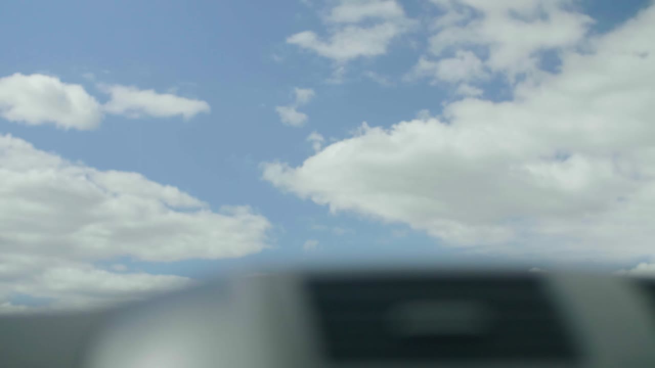 Car driving past Dandenong highway sign looking up at the sky