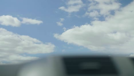 Car-driving-past-Dandenong-highway-sign-looking-up-at-the-sky