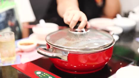 preparing a hotpot meal in a bangkok setting