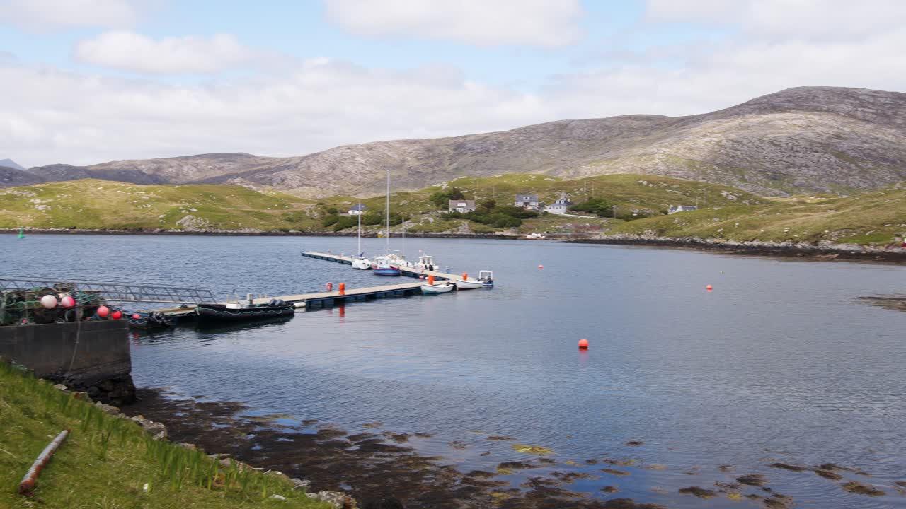 Panning midday shot of the pontoon in the harbour on the Isle of Scalpay