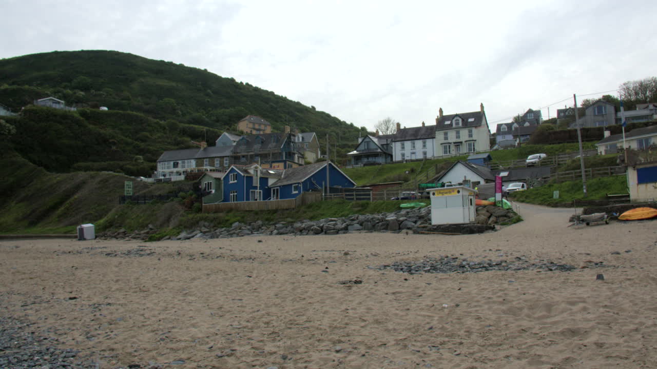 Panning Wide shot locking up to the village of Tresaith from Tresaith beach