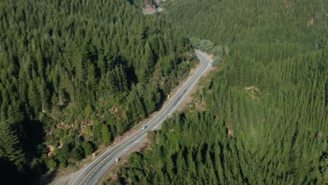 dolly zoom aerial of van on forest road