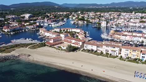 Beach-vacation-idyllic-location,-luxury-yachts,-French-port,-aerial-parallax