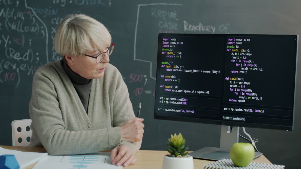 Senior Female Professor Teaching Programming