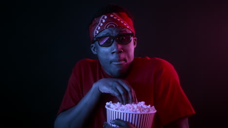 man watching a 3d movie with popcorn