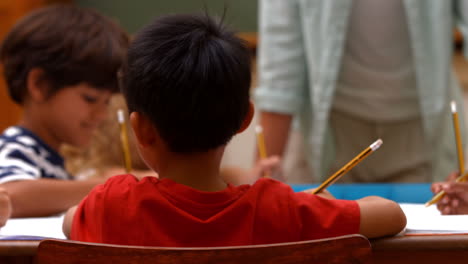 cute pupils in classroom at school
