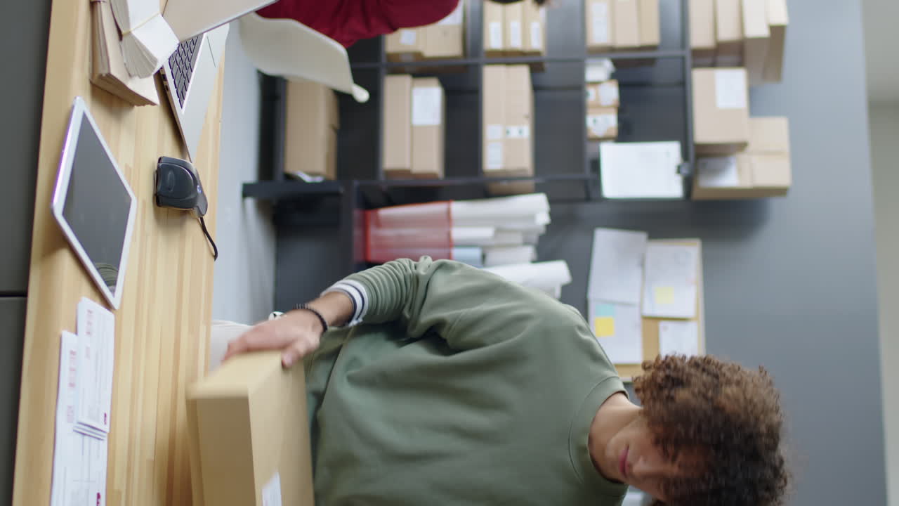 Delivery Service Worker Packing and Scanning Parcel