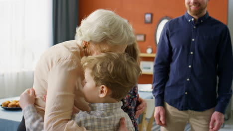 joyous grandma greeting little grandkids at home