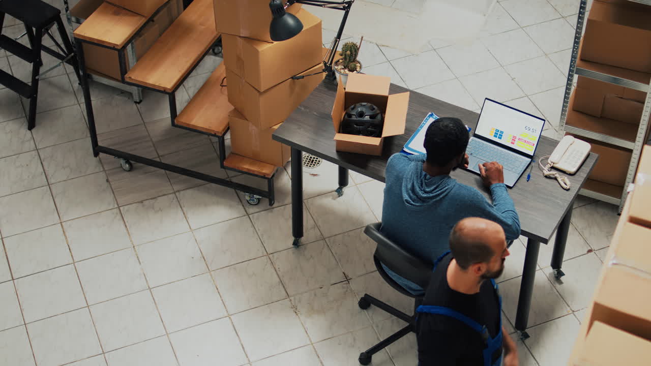 Warehouse office with worker packing boxes