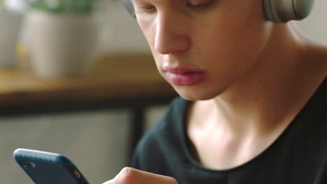 young man using smartphone with headphones