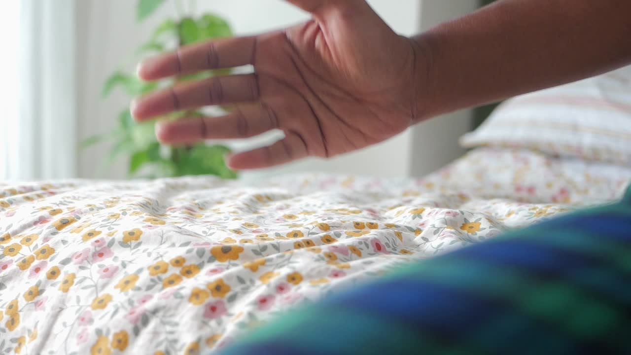 Hand on Floral Bed